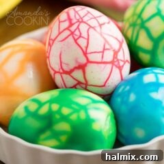 close up photo of crackled colored eggs in a nest