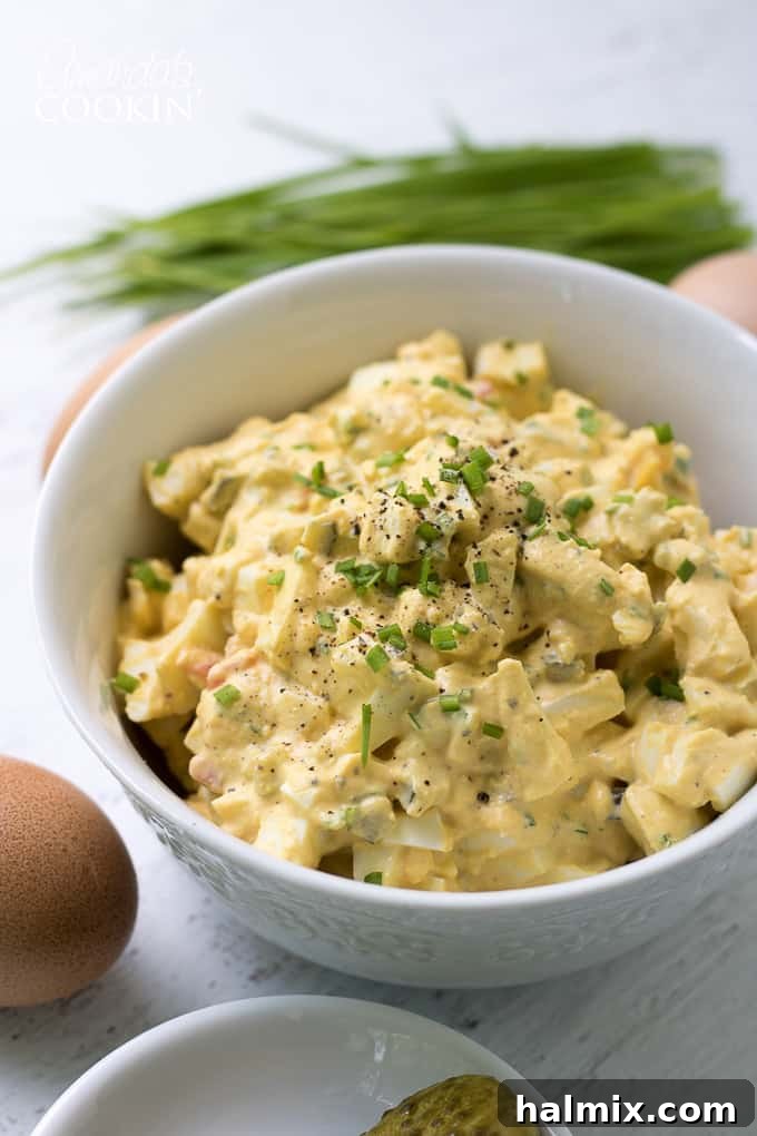 Delicious Egg Salad with fresh chives, garnished beautifully and ready to serve. Ideal for summer gatherings, potlucks, or a refreshing lunch.
