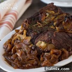 A succulent Amish pot roast served on a platter with onions, ready to eat.