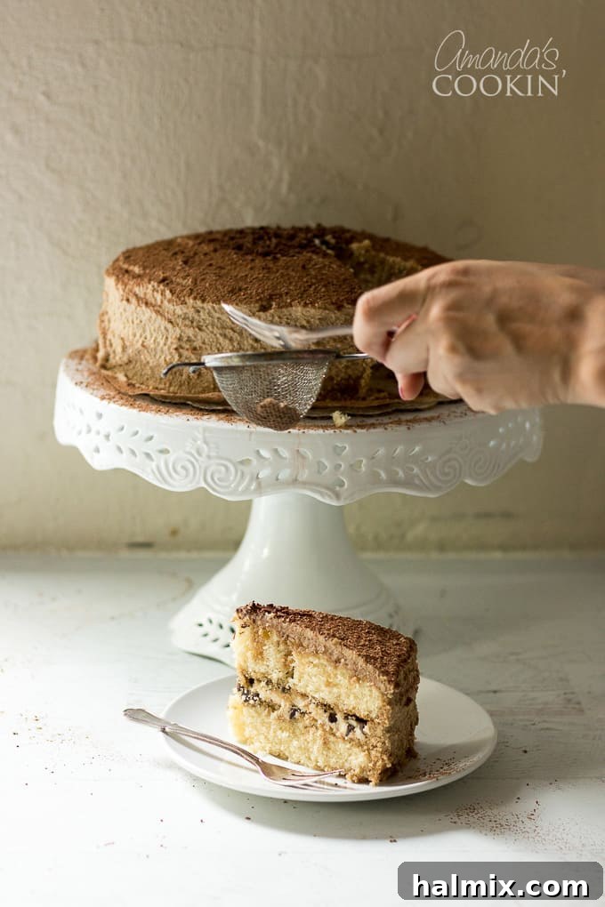 slice of tiramisu cake on a plate with a fork
