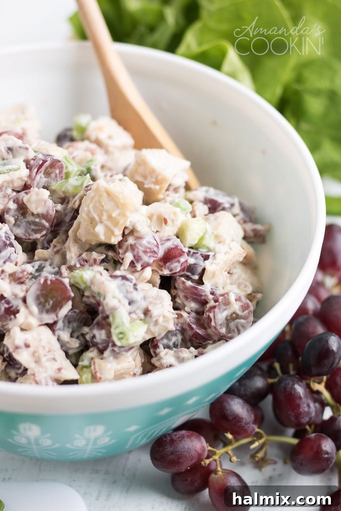Delicious Chicken Salad with Grapes - The Ultimate Summer Potluck Recipe A bowl brimming with creamy chicken salad featuring bright red grapes, perfect for a summer gathering.