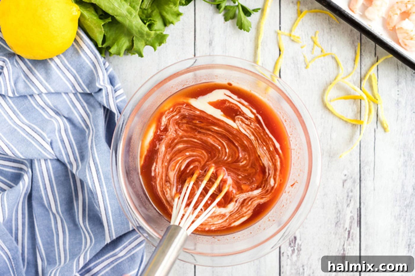 Whisking cocktail sauce ingredients in a bowl