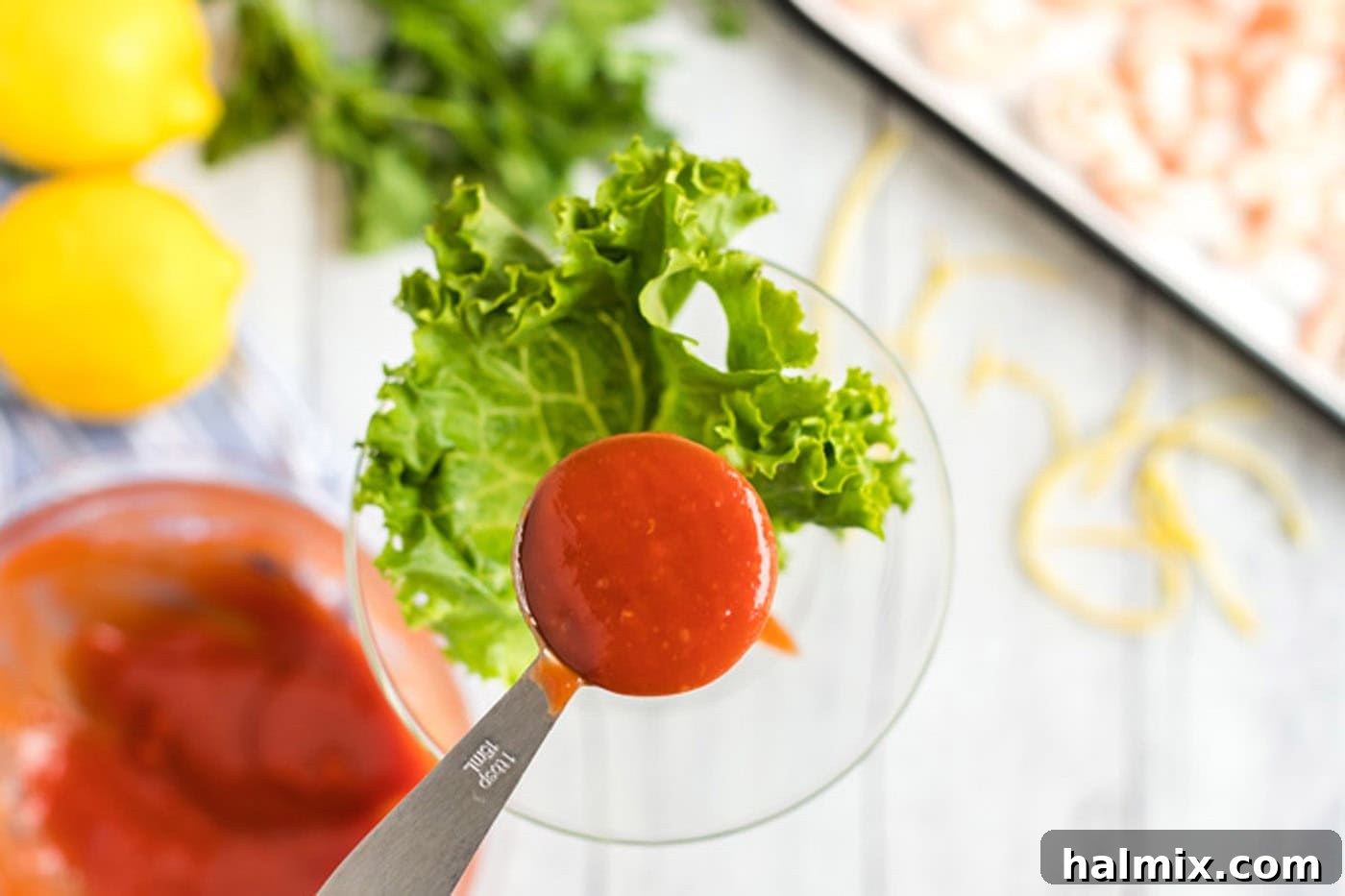 adding cocktail sauce to martini glass