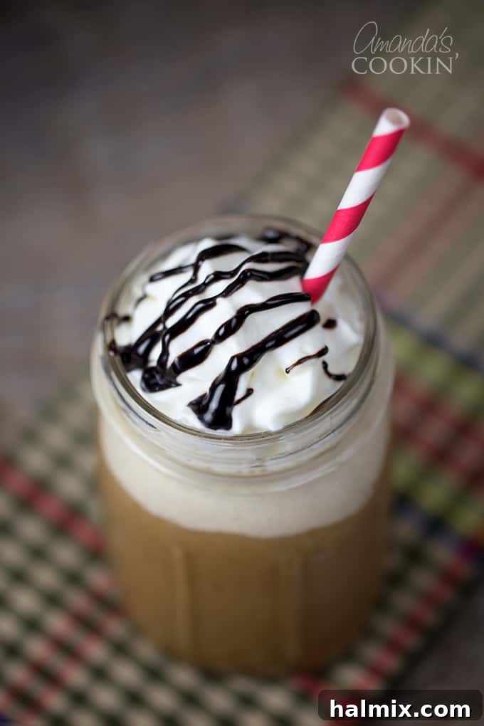 Homemade Mocha Frappe Magic 3 A vibrant close-up of a Homemade Mocha Frappuccino, similar to a Starbucks blended coffee drink, with a focus on its rich texture and topping.