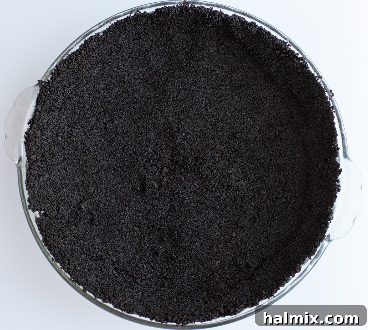 Emerald Mint Delight 6 Firmly pressed chocolate graham cracker crust inside a pie plate, ready for freezing.