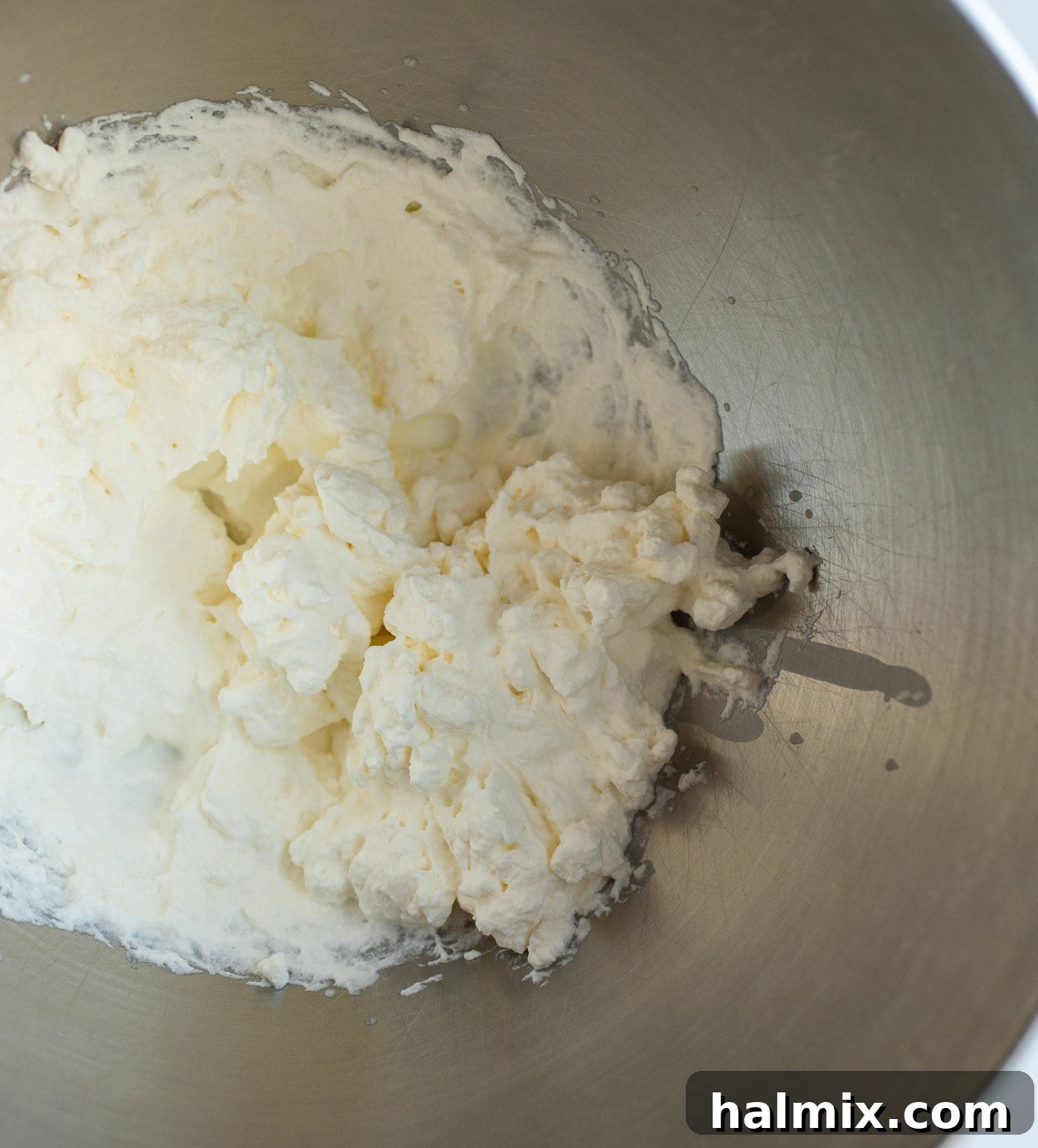 Emerald Mint Delight 7 Marshmallows and heavy cream melting together in a double boiler, forming a smooth, white mixture.