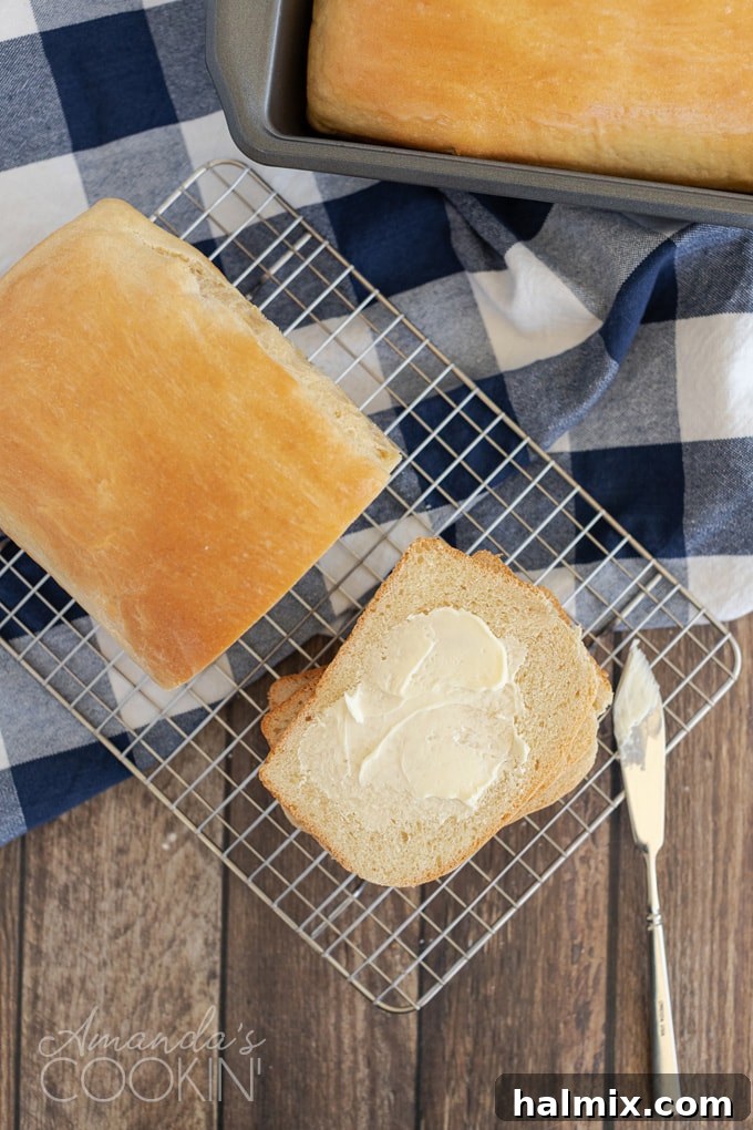 overhead view of amish white bread with a buttered slice