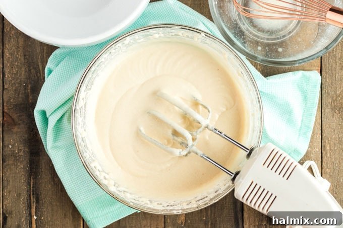 Timeless Vanilla White Cake 6 white cake batter in a bowl with a mixer