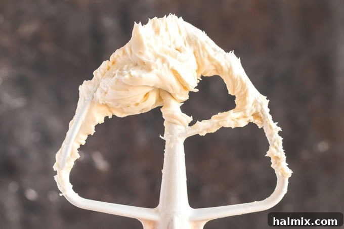 Timeless Vanilla White Cake 8 stand mixer paddle attachment covered in cream cheese mixture