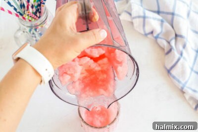 pouring slushie from blender into glass