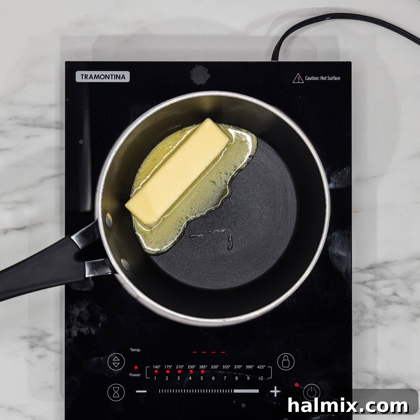 Melting butter in a saucepan, beginning to brown and release a nutty aroma.