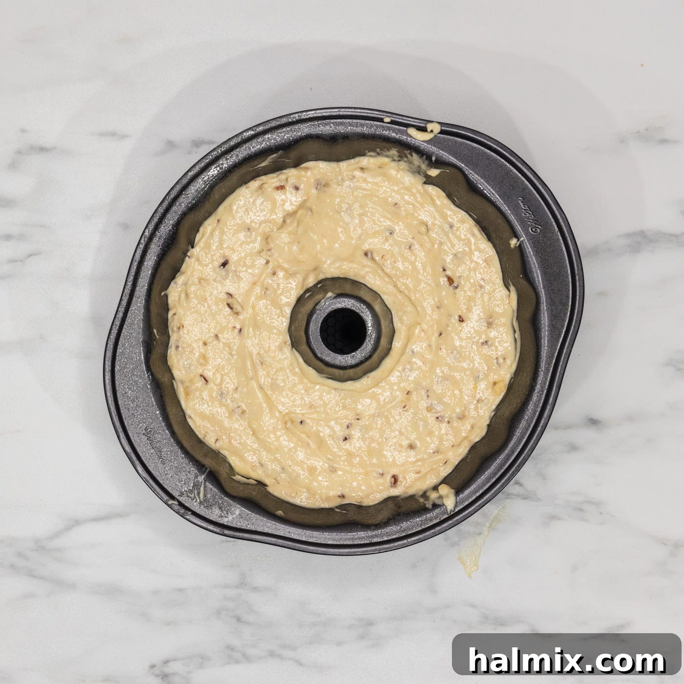 Banana bundt cake batter neatly poured into a bundt pan, ready for baking.
