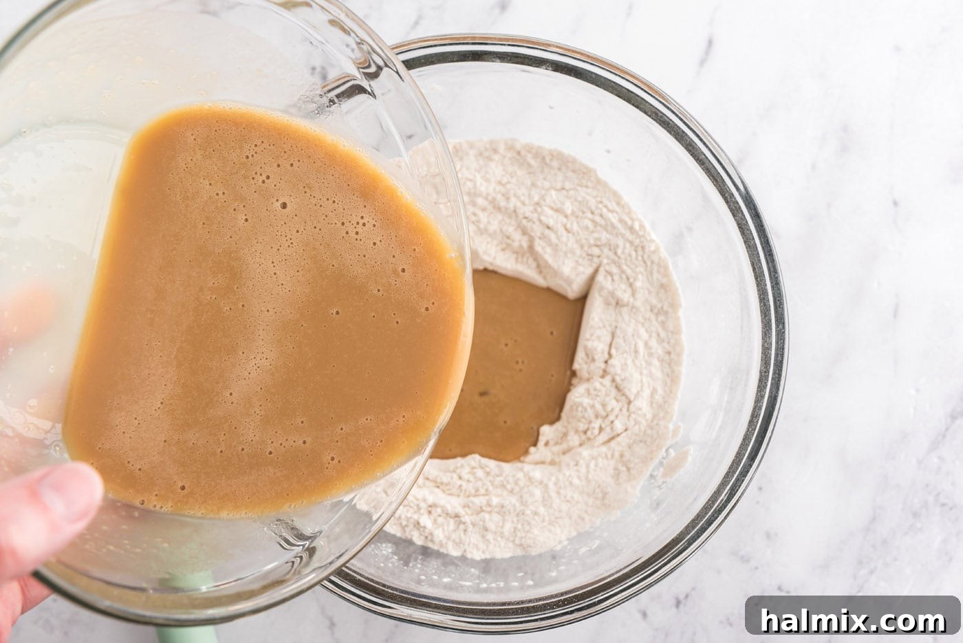 pouring wet ingredients into dry ingredients for muffins