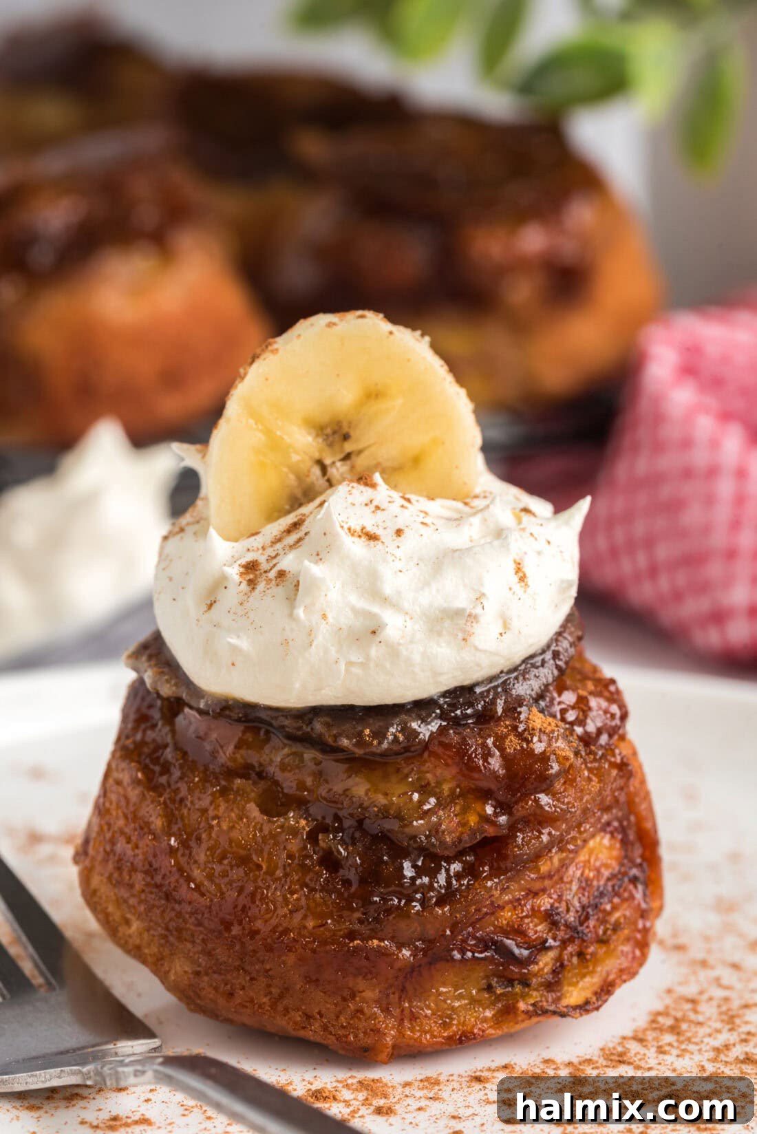 Banana Upside Down Muffin topped with whipped cream and a banana slice