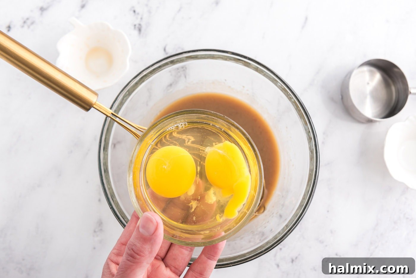 adding eggs to whisked brown sugar, milk, and rum mixture
