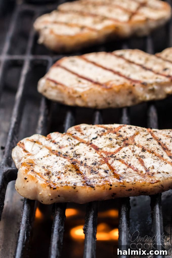 Learn how to make the perfect grilled pork chops. My go-to marinade is very easy and includes lemon juice, olive oil, garlic and a few fresh herbs. pork chops on the grill