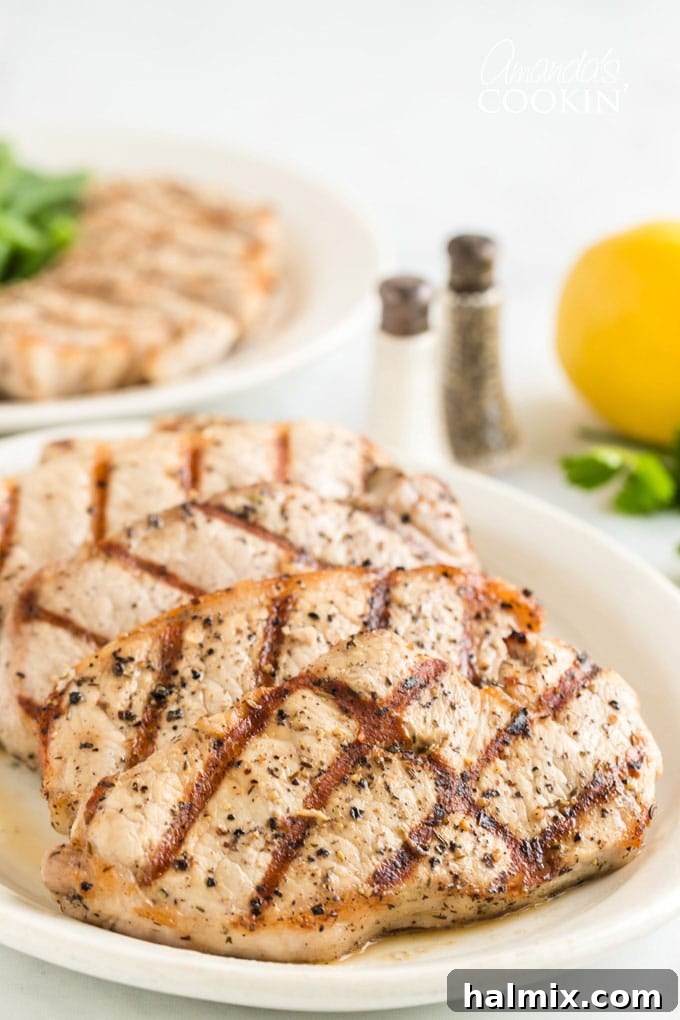 Learn how to make the perfect grilled pork chops. My go-to marinade is very easy and includes lemon juice, olive oil, garlic and a few fresh herbs. grilled pork chops on a platter