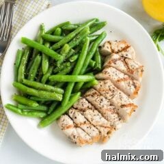 Zesty Lemon Herb Grilled Pork Chops 6 A plate of food with pork chops and green beans