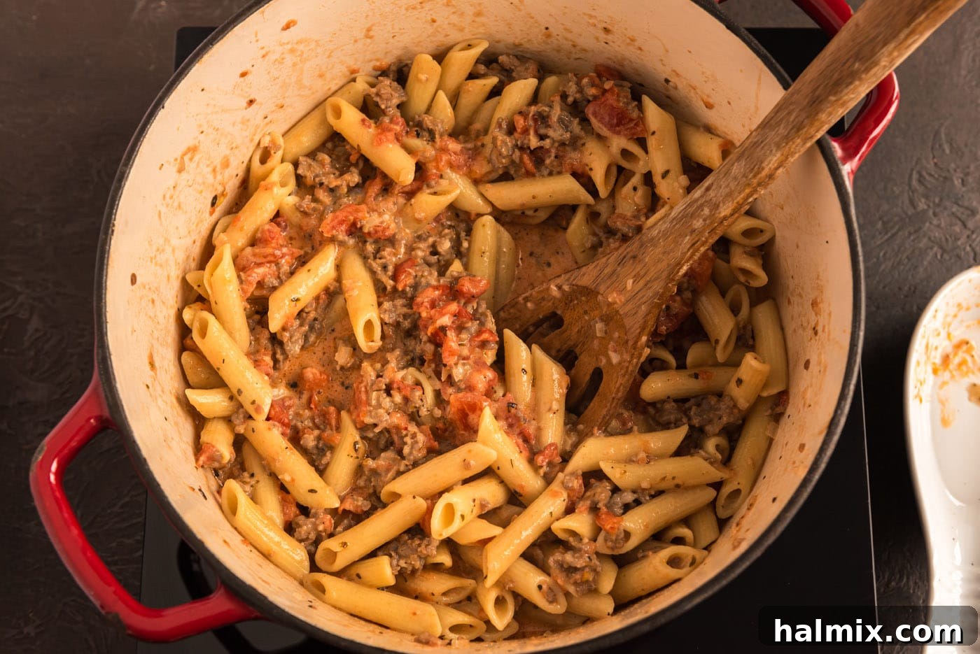 penne with tomato sage sausage sauce in a pot