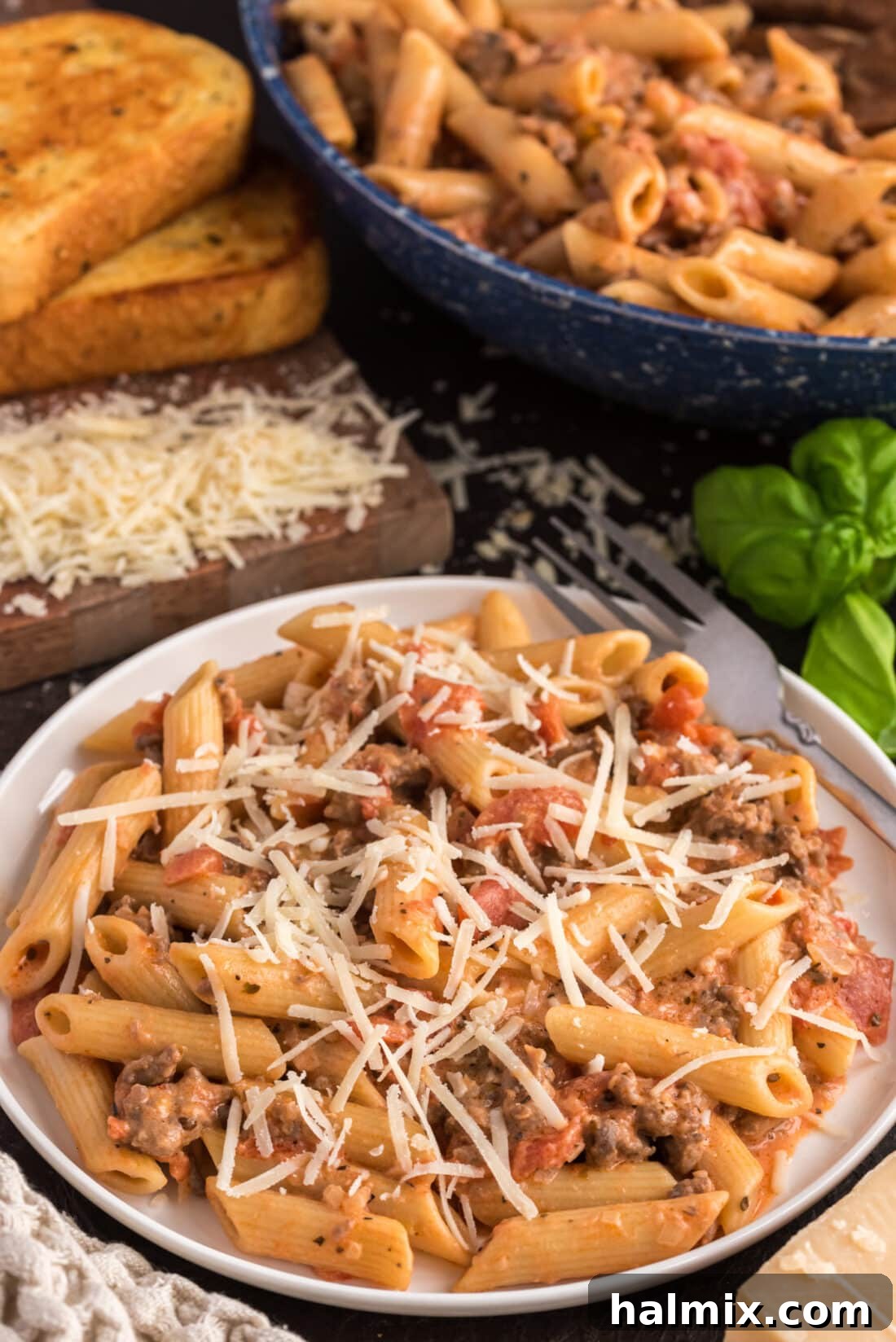 Plate of Penne with Tomato Sage Sausage Sauce topped with cheese