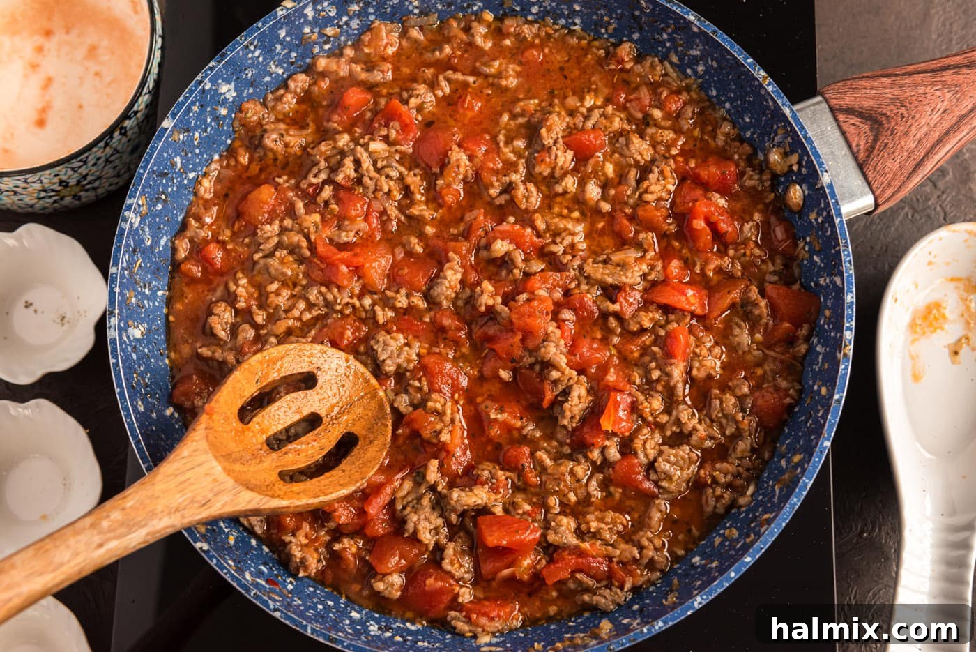 ground sausage tomato sauce in a skillet