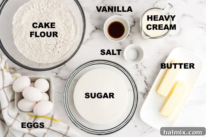 Ingredients for Homemade Whipping Cream Pound Cake A flat lay of all the essential ingredients for whipping cream pound cake, including butter, flour, sugar, eggs, vanilla, and heavy cream, neatly arranged on a kitchen counter.