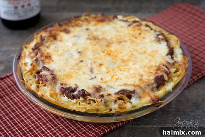 Golden Crust Spaghetti Pie 9 A beautifully presented spaghetti pie, labeled as an easy weeknight dinner, ready to serve.