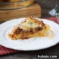 A slice of spaghetti pie on a white plate.