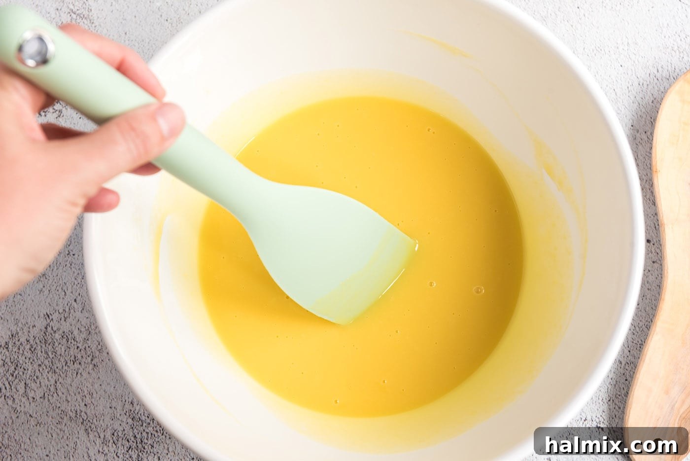 Egg mixture being stirred with white chocolate pieces
