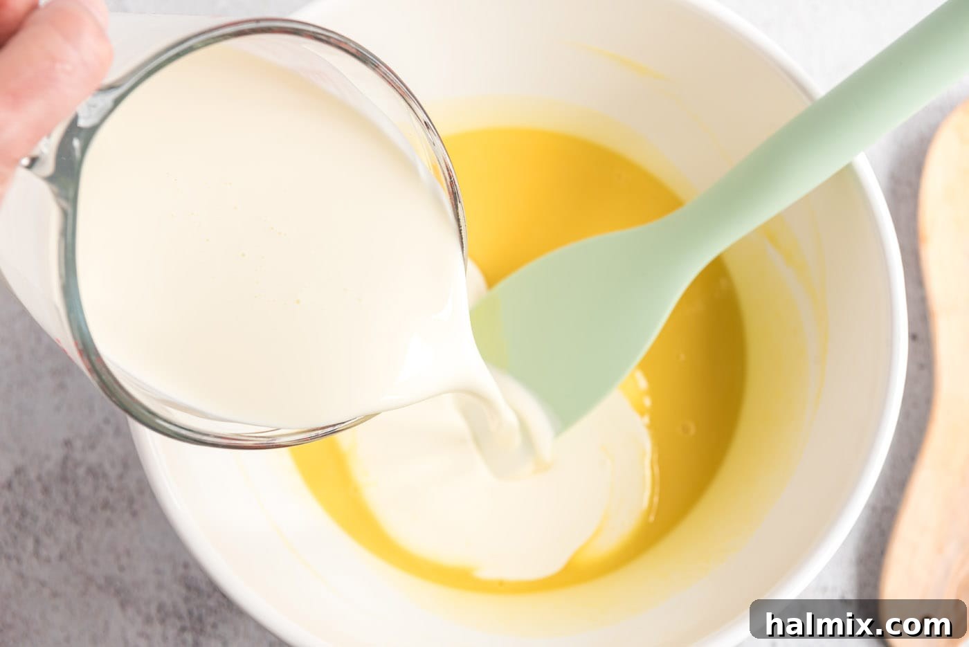 Cream being poured into the custard