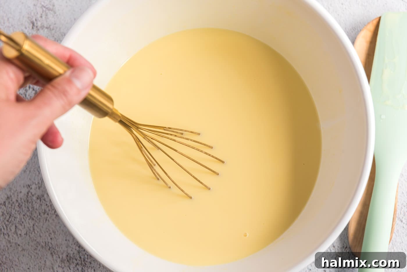 Custard mixture being stirred over an ice bath