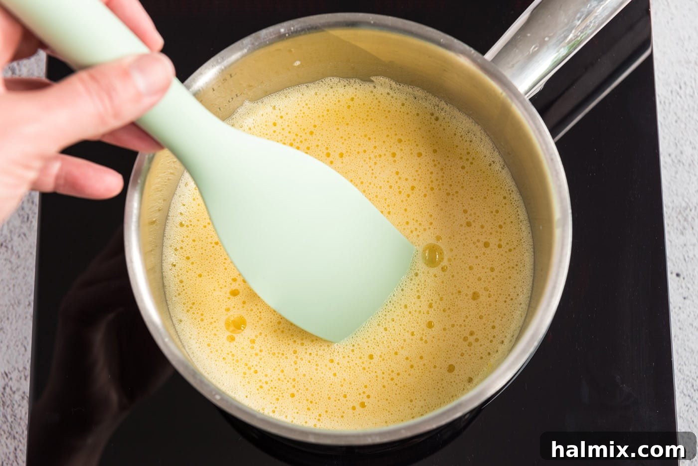 Warmed egg yolk mixture in a saucepan