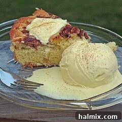 A scoop of cinnamon ice cream on a plate next to a slice of Milopita.