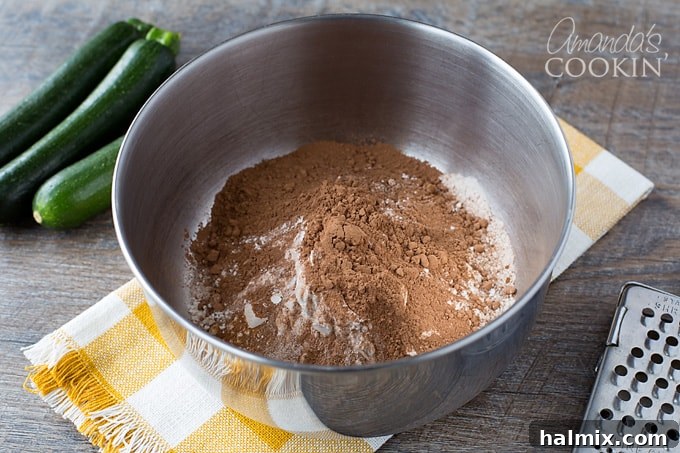 Secret Garden Chocolate Loaf 3 Flour, cinnamon, baking soda, salt, and cocoa powder being whisked together in a bowl.