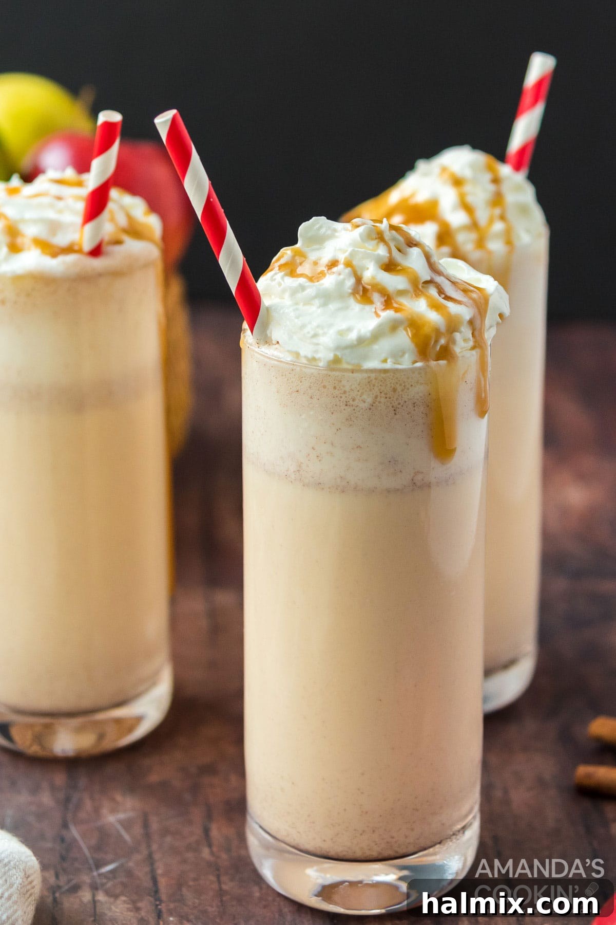 Only 3 ingredients for this delicious, fall inspired apple cider milkshake. So easy to make and a an amazing way to wrap up summer. Three creamy apple cider milkshakes garnished with whipped cream and cinnamon