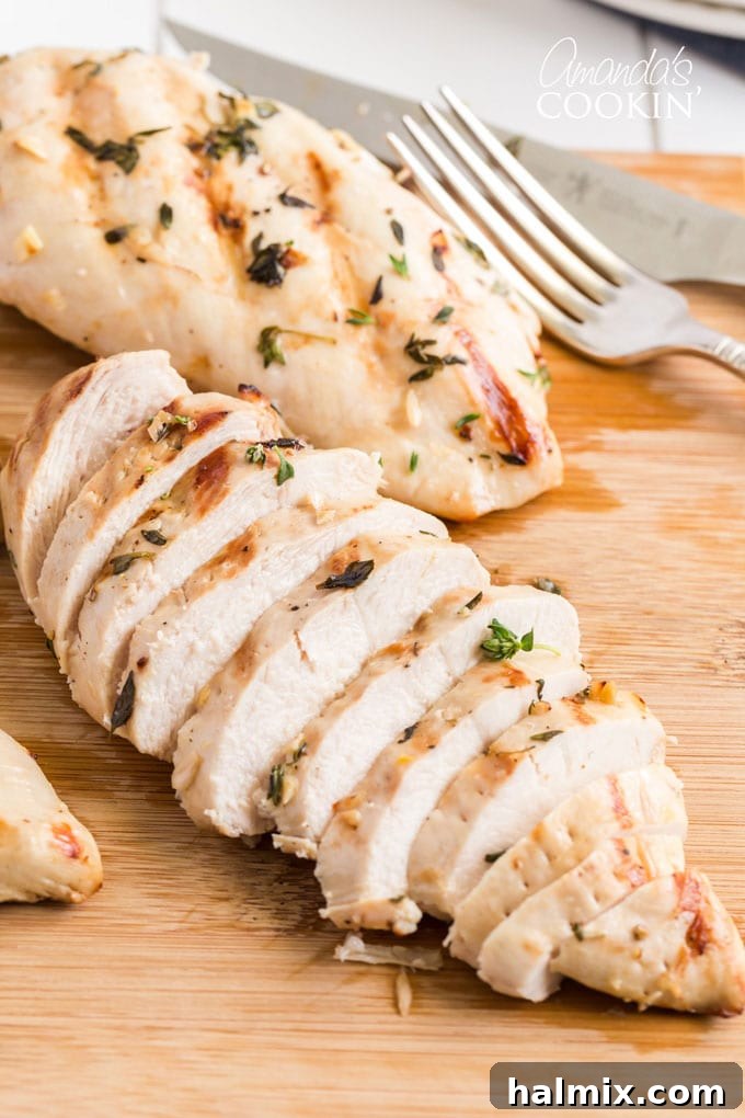 Close-up of perfectly sliced grilled chicken breast showing its tender, juicy interior.