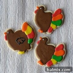 A photo of three thanksgiving turkey cookies.