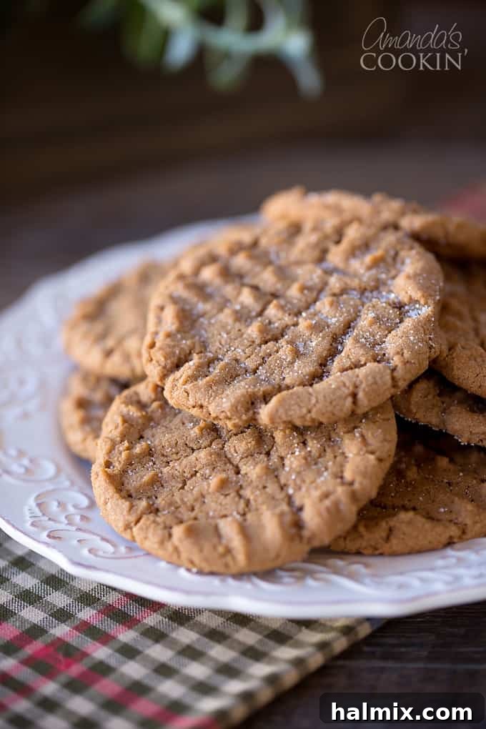 Nutella Swirl Peanut Butter Cookies 2 A close-up photograph showcasing freshly baked Nutella Peanut Butter Cookies, some stacked on a rustic plate, invitingly warm and ready to be enjoyed.