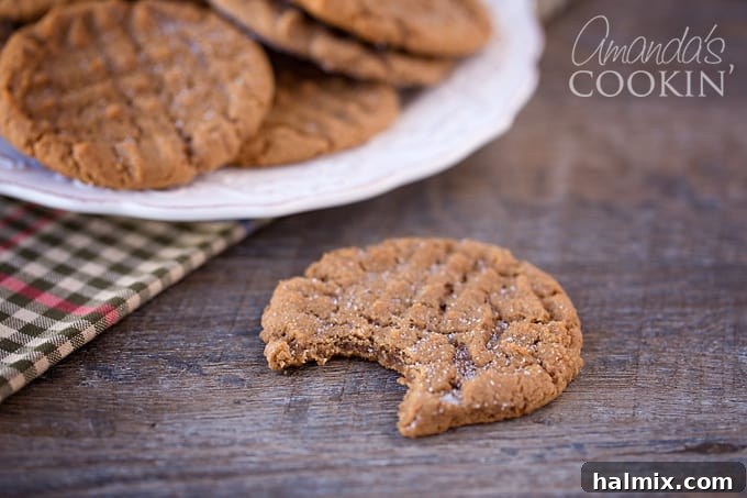 Nutella Swirl Peanut Butter Cookies 3 A top-down shot of a small batch of Nutella Peanut Butter Cookies arranged neatly on a serving platter, highlighting their golden brown edges and signature fork marks.