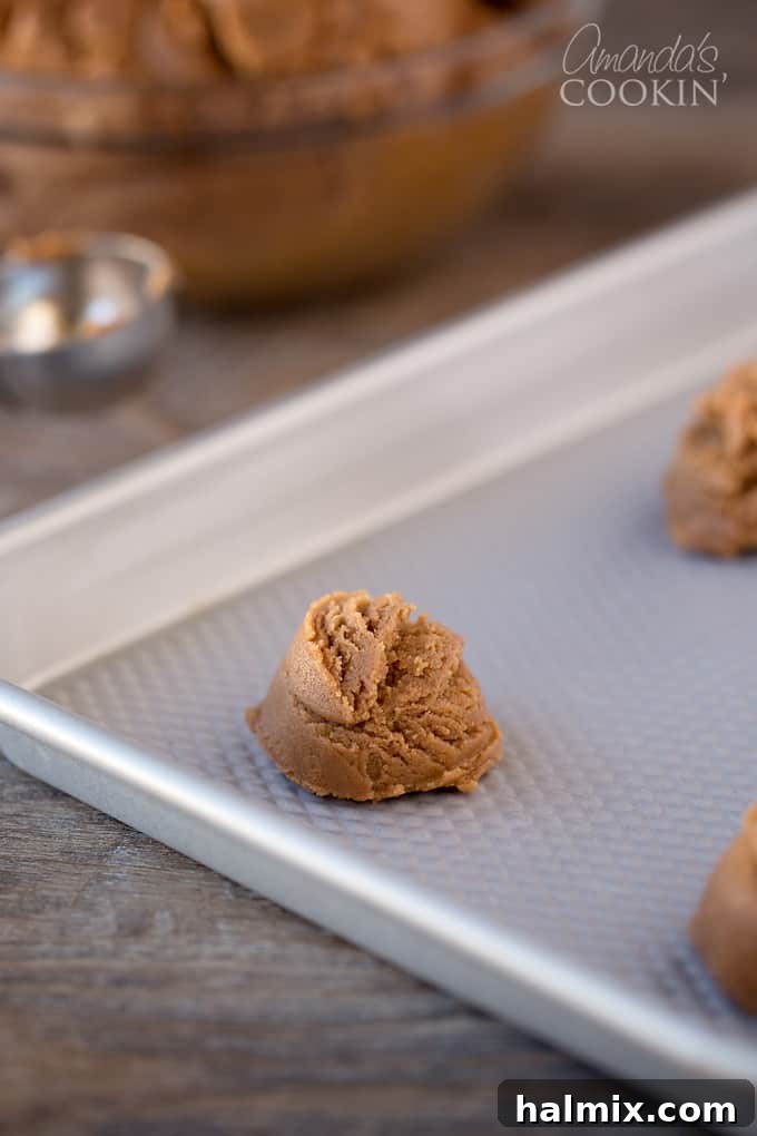 Nutella Swirl Peanut Butter Cookies 5 A step-by-step photo showing the initial mixing of shortening, Nutella, peanut butter, and sugar in a large bowl, demonstrating the smooth texture before adding other ingredients.