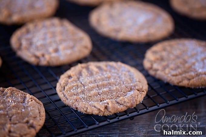 Nutella Swirl Peanut Butter Cookies 7 A close-up shot of cookie dough balls on a baking sheet, featuring the distinctive criss-cross pattern pressed into them with a fork, ready for the oven.