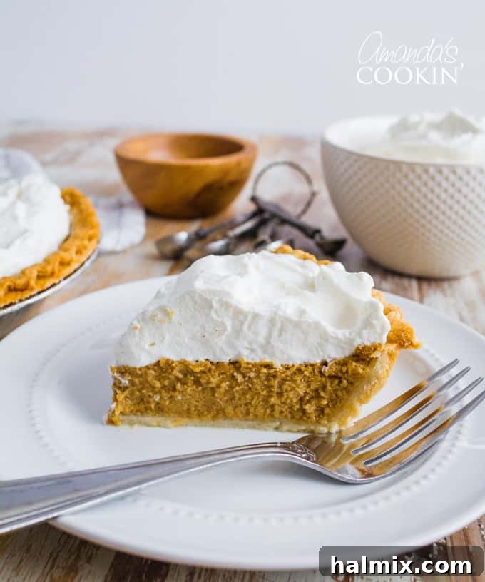 An overhead shot of a perfectly baked pumpkin pie, adorned with a delicate swirl of whipped cream, inviting guests to a holiday feast.