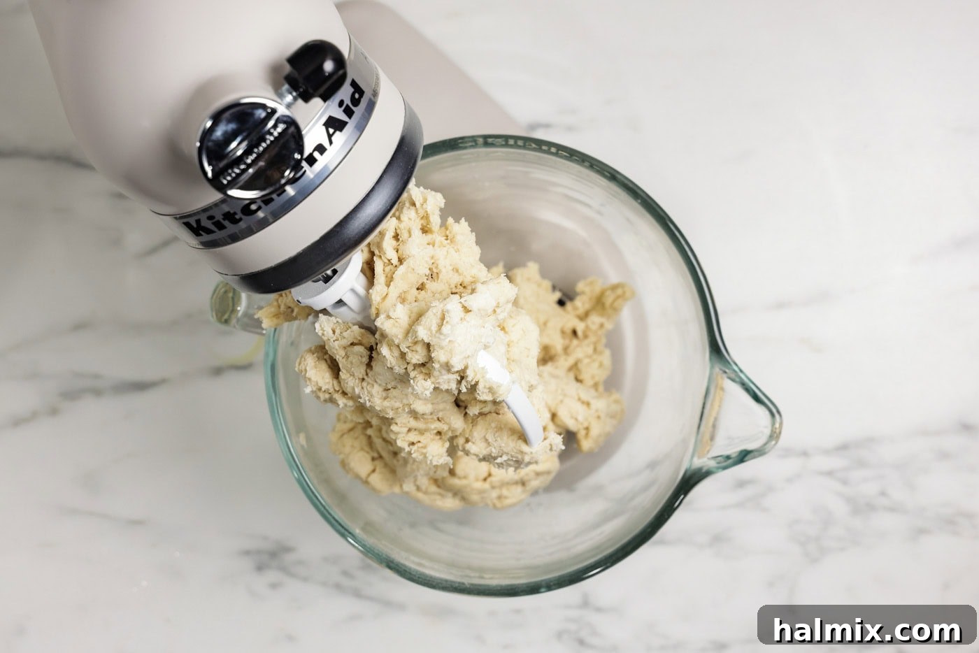 The 60-Minute Loaf 5 bread dough ingredients in a stand mixer bowl showing dry ingredients mixed with wet