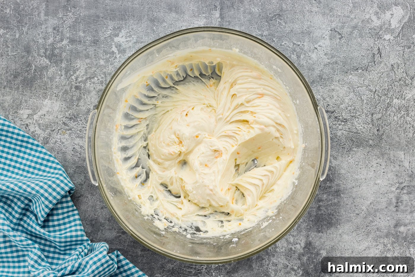 Orange cream cheese frosting in a mixing bowl