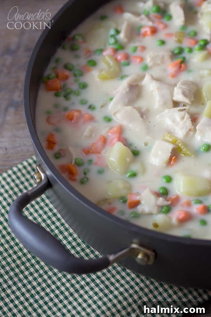 A close-up of the rich, creamy gravy for homemade pot pie, cooked to perfect thickness and golden color.