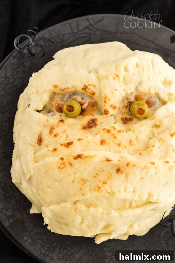 Halloween Mummy Meatloaf on a plate, ready to be served