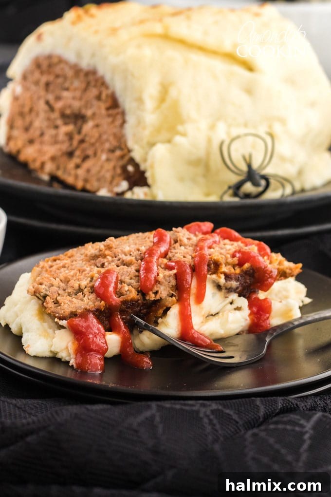 A serving of Mummy Meatloaf, perfectly sliced, with ketchup blood