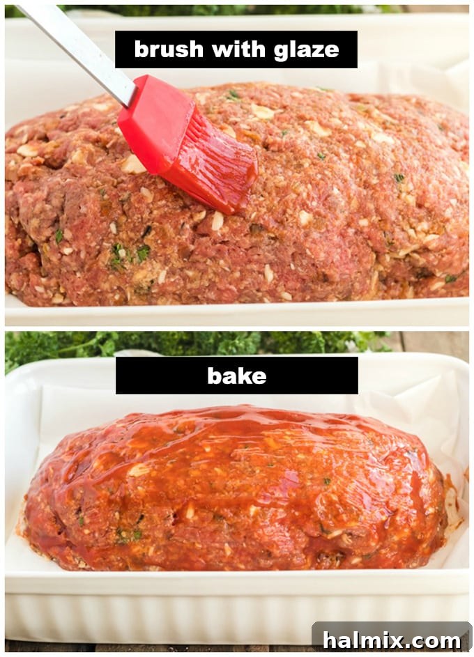 A meatloaf being brushed generously with a savory-sweet glaze before baking
