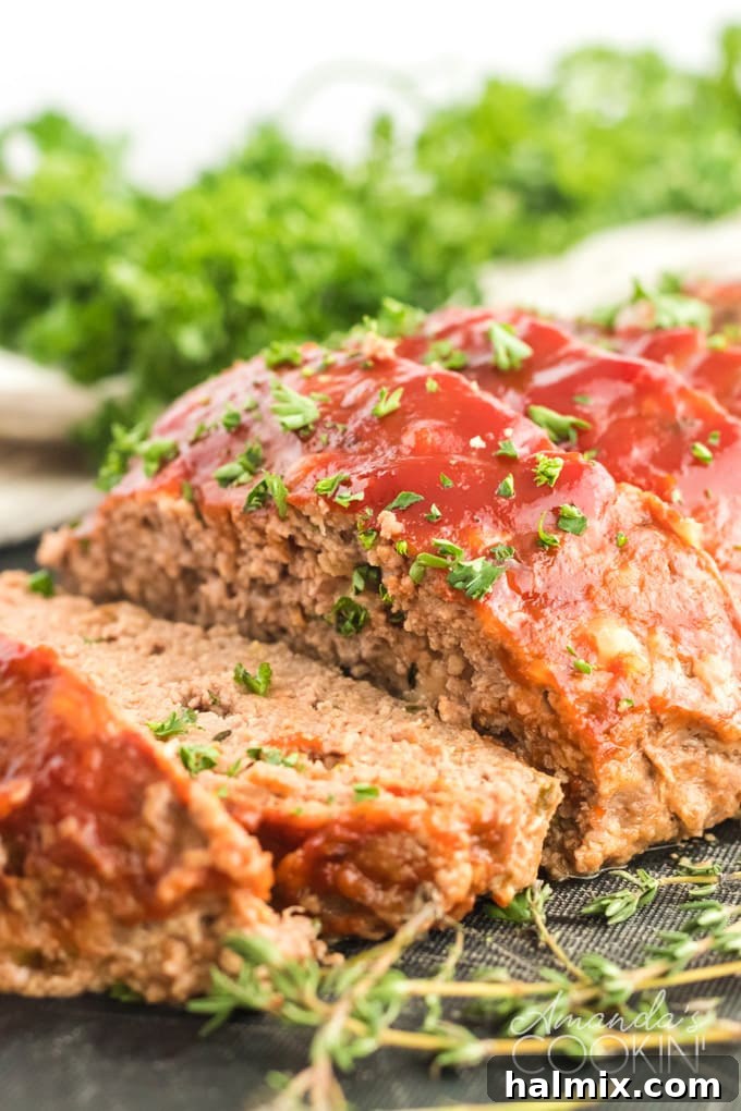 Perfectly sliced meatloaf with a glistening ketchup glaze, ready for serving