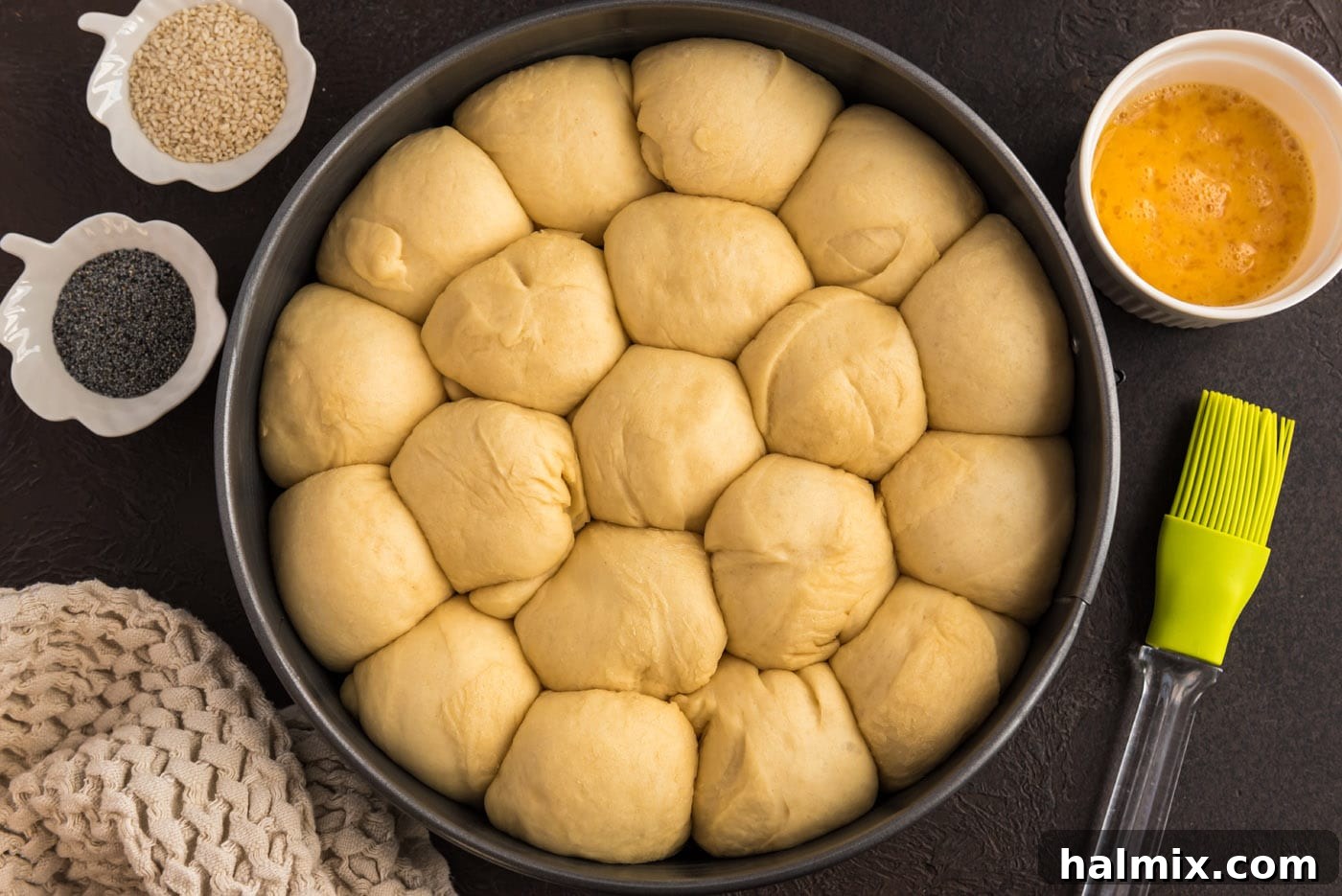 Proofed dough balls in a springform pan, showing they have doubled in size and are close together.